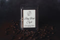 Story Wick Cafe wax melt packaging with coffee beans on a dark background.