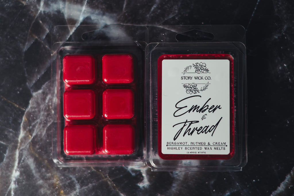 Pack of red wax melts with 'Ember & Thread' label on a dark marble background